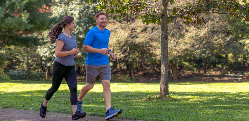 Man and woman running outdoors