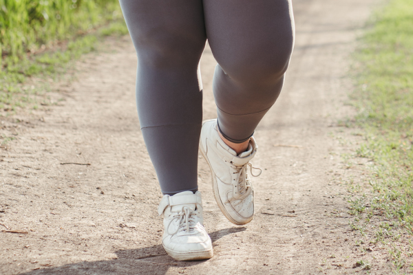 closeup of lower body of overweight person running