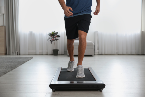 man walking on a walking pad treadmill inside