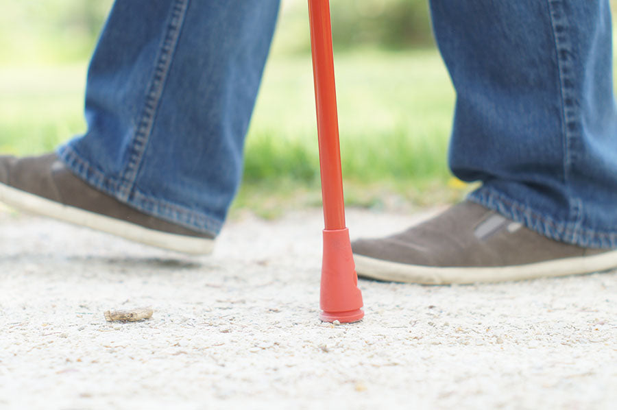 close up of shoes while walking with a cane