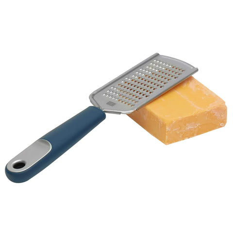 The MGD Flat Cheese Grater on a block of cheese