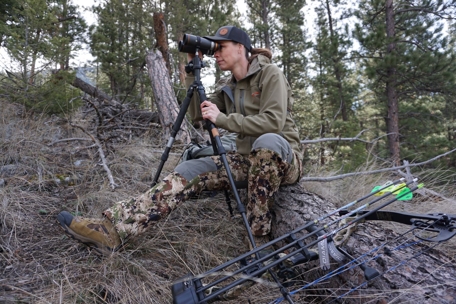The author’s wife uses binoculars with Ascent tripod for archery hunt