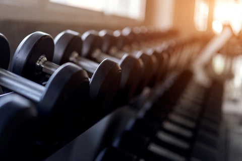 blurred-background-rows-black-dumbbells-rack-gym