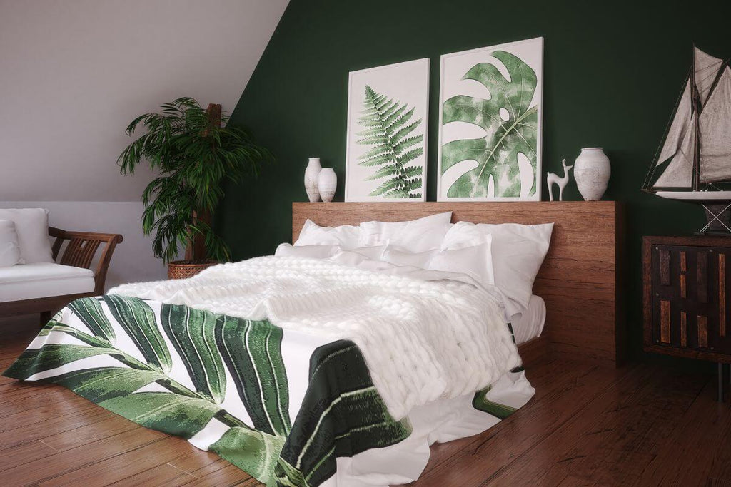 Bedroom with green leaf-inspired artwork above bed