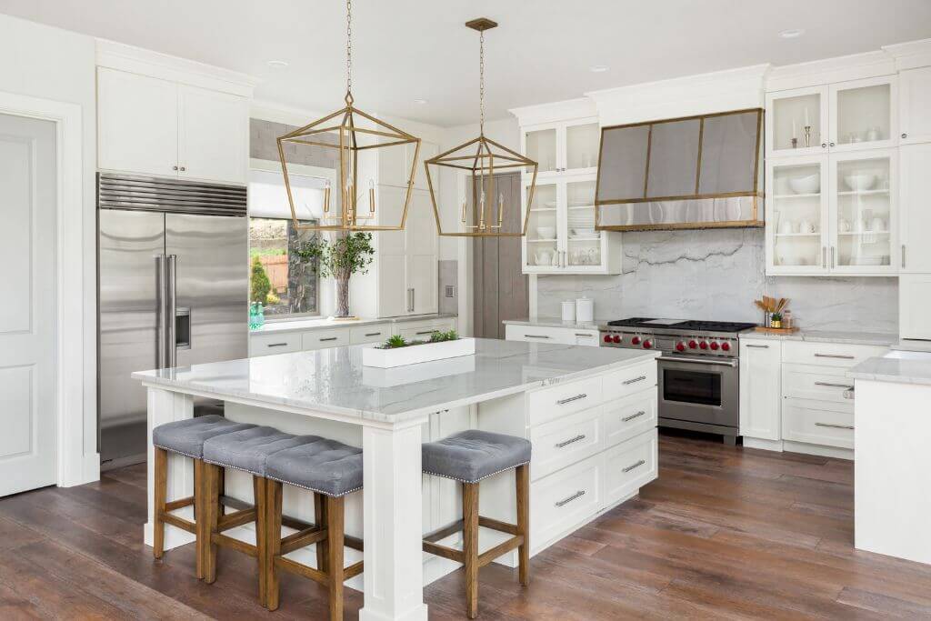 Modern kitchen with gold pandants above kitchen island