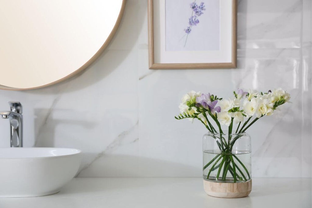 Glass and wooden vase on the bathroom counter