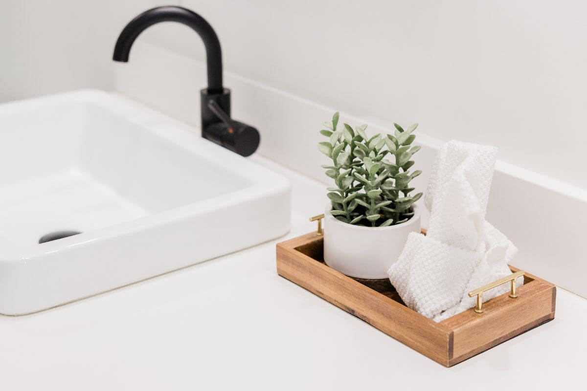 Wooden and gold tray in the bathroom