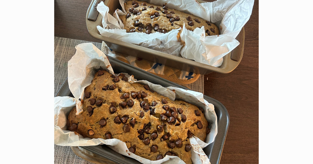 Two loaves of banana bread topped with chocolate chips