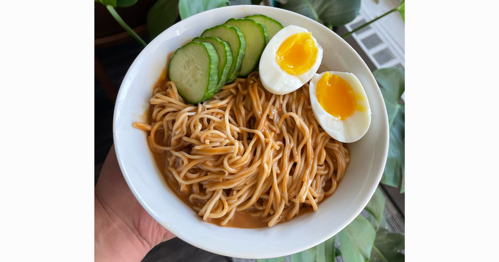 Peanut butter noodles with soft-boiled eggs and cucumbers