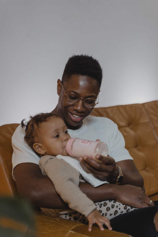 dad feeding baby