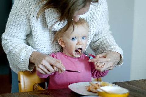 mom feeding toddler