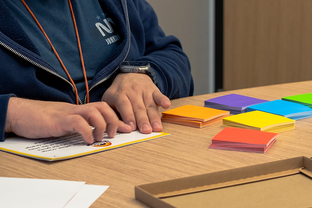 Image of a Technology Accessibility Specialist from LightHouse SF testing the Braille on our sticky notes