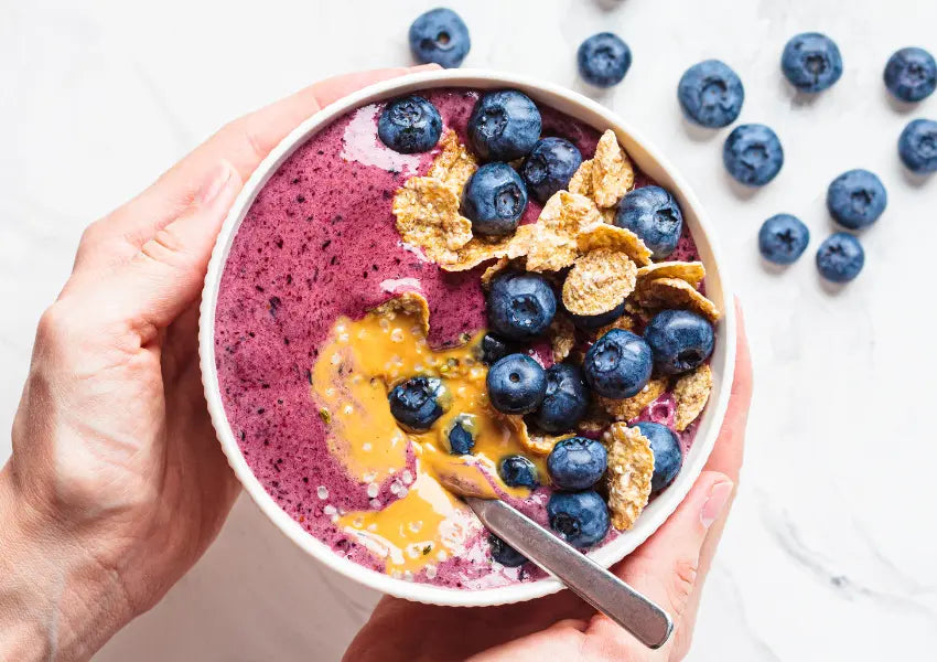 peanut butter acai berry bowl topped with blueberries