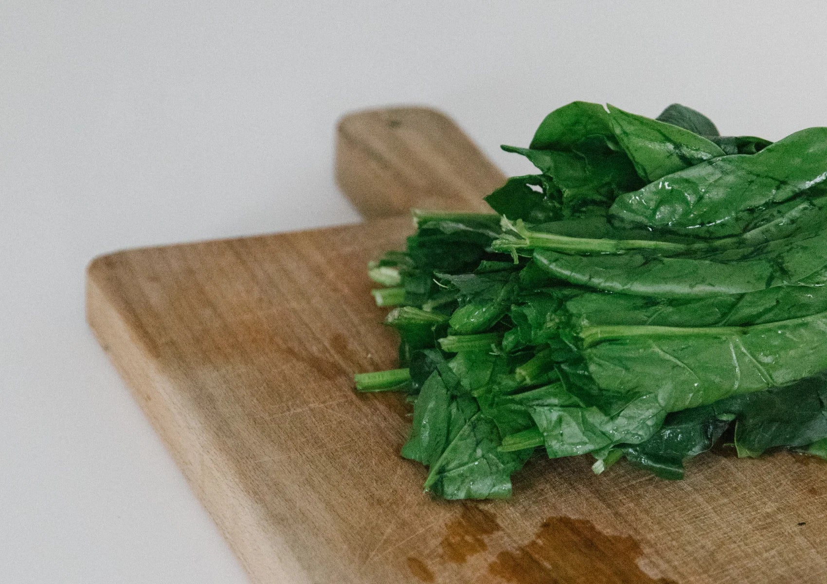 leafy vegetables on chopping board