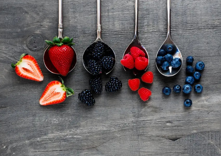 assortment of berries including strawberries, blackberries, raspberries and bleuberries from top view