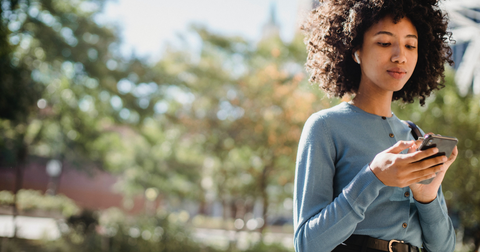 Girl using managing her social media in the street