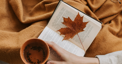 A woman reading with her cup of coffee