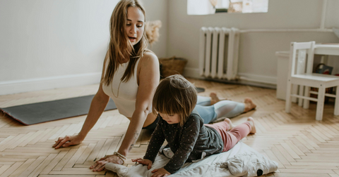 A woman working out with her kid, having a more inclusive environment and accomplishing goals