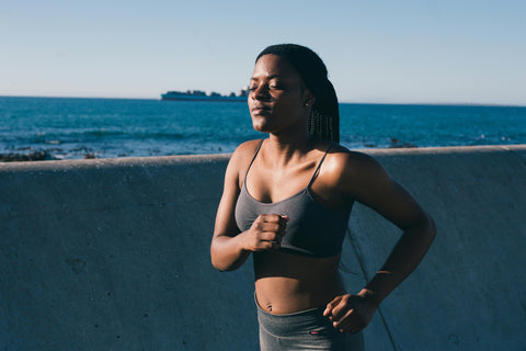 Photo by RF._.studio: https://www.pexels.com/photo/photo-of-woman-in-gray-spaghetti-strap-top-and-gray-pants-running-beside-concrete-wall-3621183/