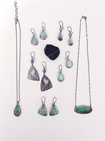 Jewelry collection featuring green chrysoprase stones, sterling silver, and some light blue stones.