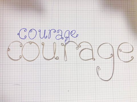 sterling silver wire shaped into letters spelling "courage"