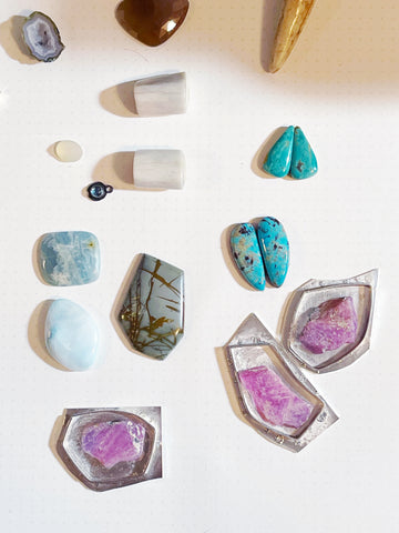 In-process jewelry featuring sterling silver shapes adorned by gorgeous rough rub and turquoise