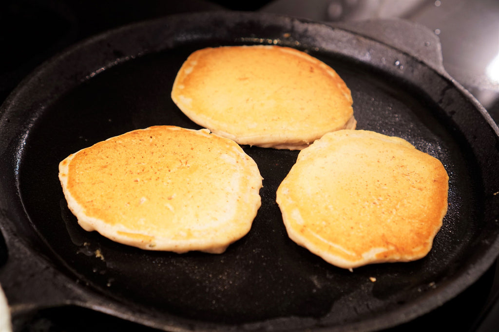 image of three pancakes on a cast iron frying pan
