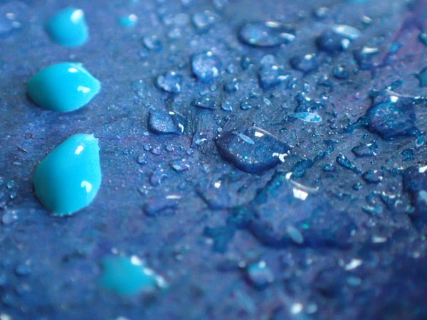 Kimberli Werner Art, water droplets scattered on dark blue background, some clear, some turquoise paint