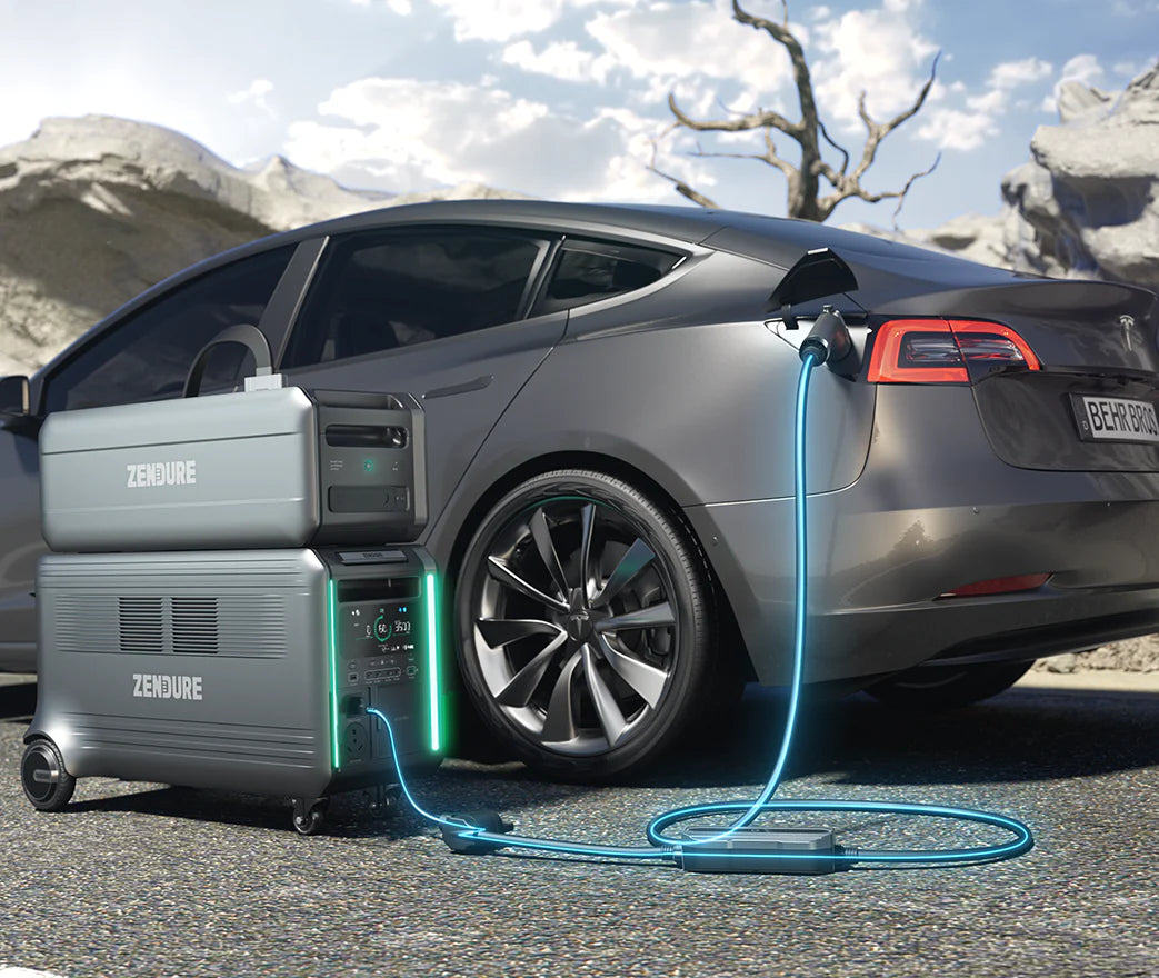 A gray electric car is parked outdoors, plugged into the Zendure SuperBase Satellite Battery from Zendure via blue cables. This portable power station supports solar panels, ideal for rocky terrain and a leafless tree under a partly cloudy sky.