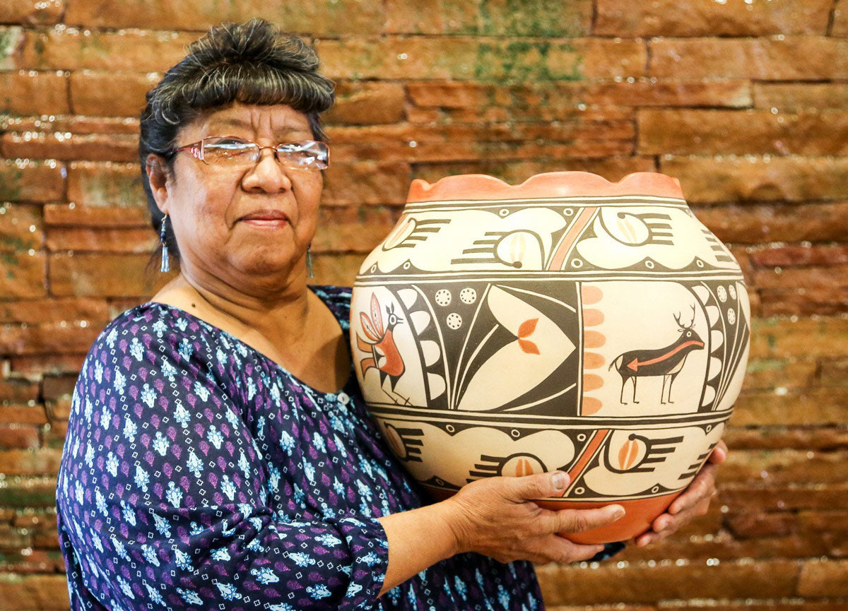 Elizabeth Medina holding her Pueblo pottery from Zia Pueblo