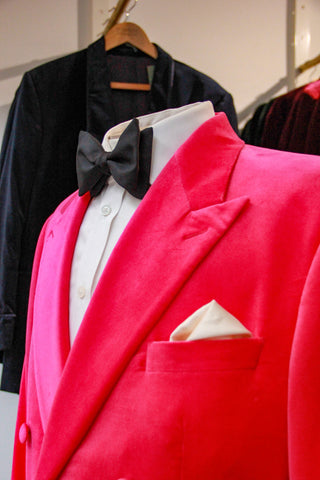 Close-up of an Oliver Brown velvet smoking jacket in cerise pink; inspired by Bond hero, Daniel Craig.