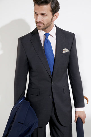 Model wearing an Oliver Brown Eaton suit in Dormeuil Plain Grey