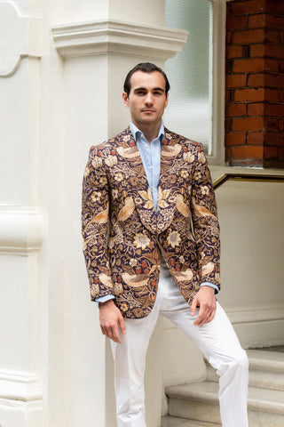 Model wearing bespoke jacket with print of William Morris' "Strawberry Thief".