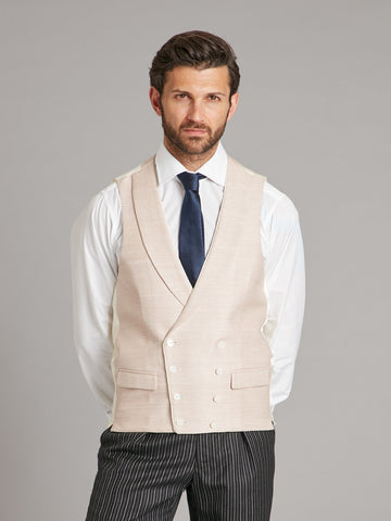 Model is wearing an Oliver Brown double breasted waistcoat in plain silk, colour Rose Smoke.