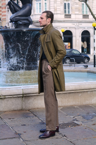 Mike Deans in Sloane Square wearing a trench coat. 