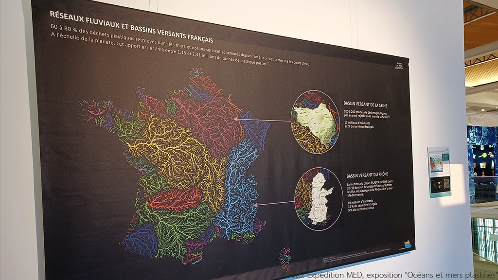 Photo by Expédition MED, exposition "Océans et mers plastifiés" - Grasshopper Geography's river basin map of France, Europe and the world on display at the exhibition Plasticized oceans and seas in Paris. The maps are printed on a 3m wide black canvas, with a small introduction of Robert Szucs, founder of Grasshopper Geography.