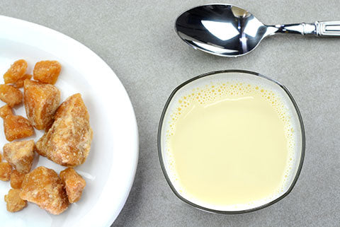 A glass of milk with jaggery