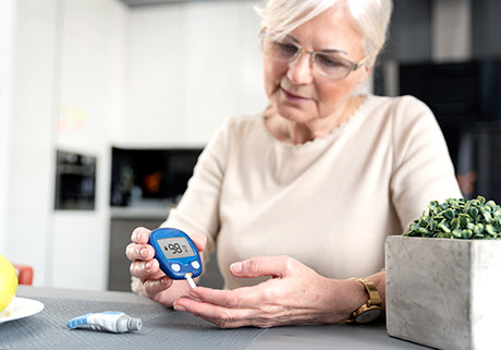 Old lady checking her glucose