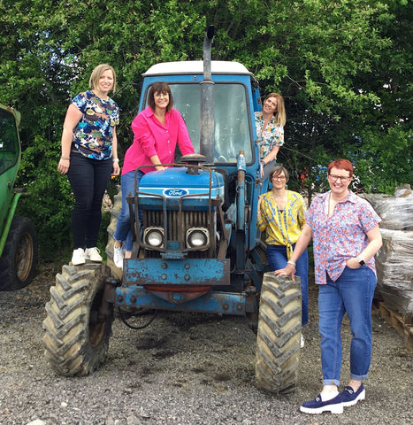 Molly Mae team standing on a tractor