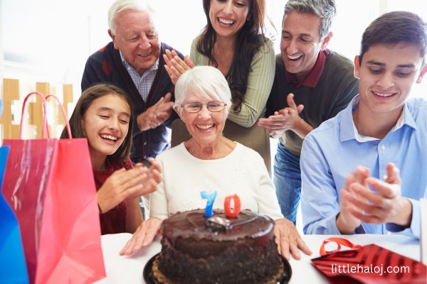 Woman celebrating 70th birthday with family