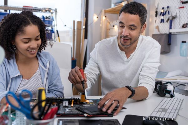 Father daughter building robot