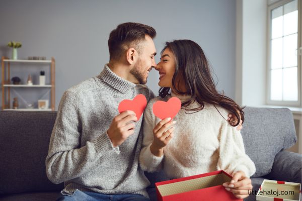 Couple holding heart shaped cards
