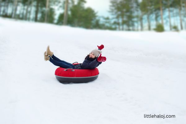 Girl sliding on the snow