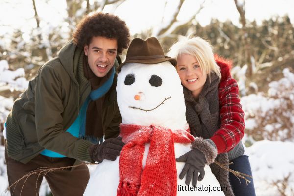 Friends building snowman