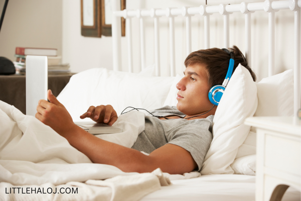 Teen in bed with headphones on