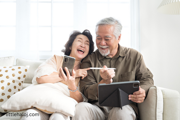 Elderly couple on couch laughing at senior puns