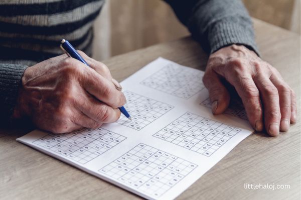 senior playing Sudoku alone