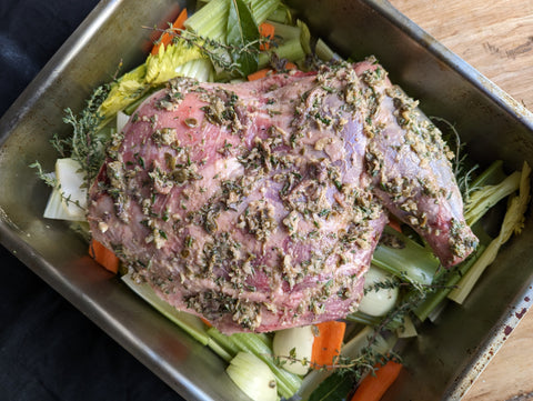 Shoulder of lamb marinating in anchovy, capers and rosemary