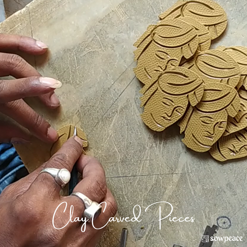 Clay is carved with design