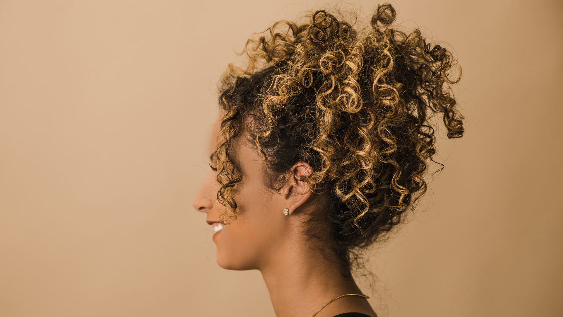 curly hair in pineapple bun for sleeping